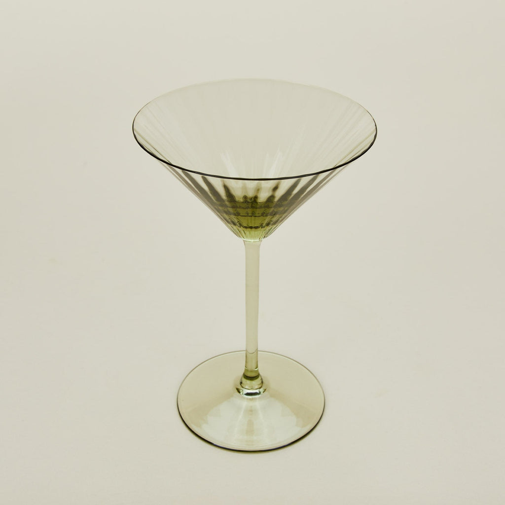 Three-quarter angle of ribbed olive martini glass.