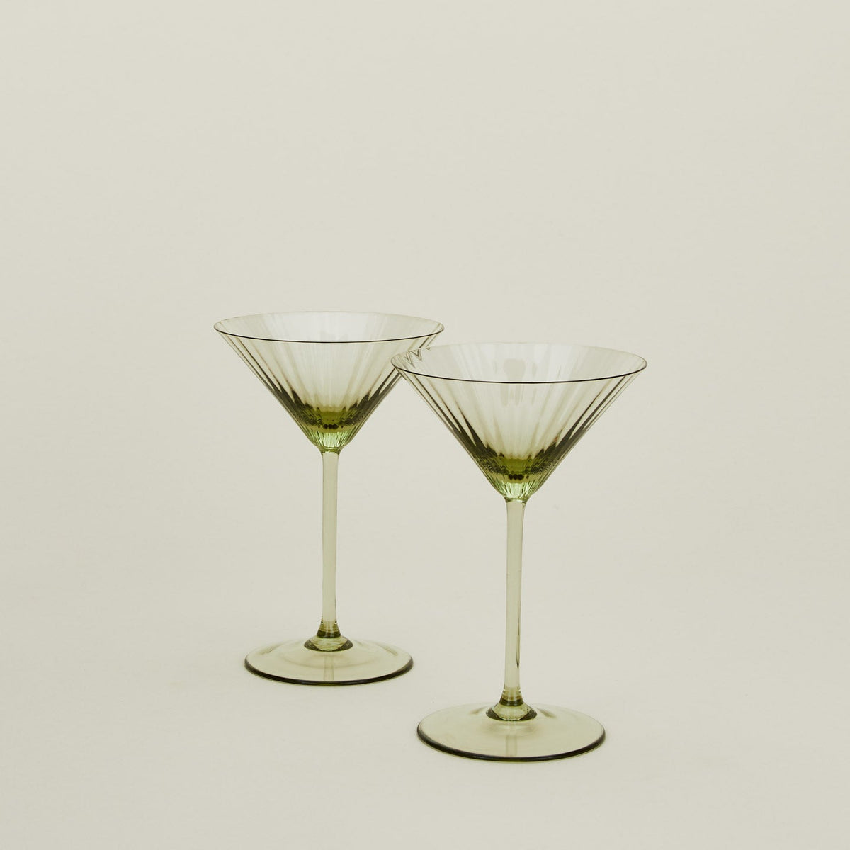 Set of two ribbed olive martini glasses.
