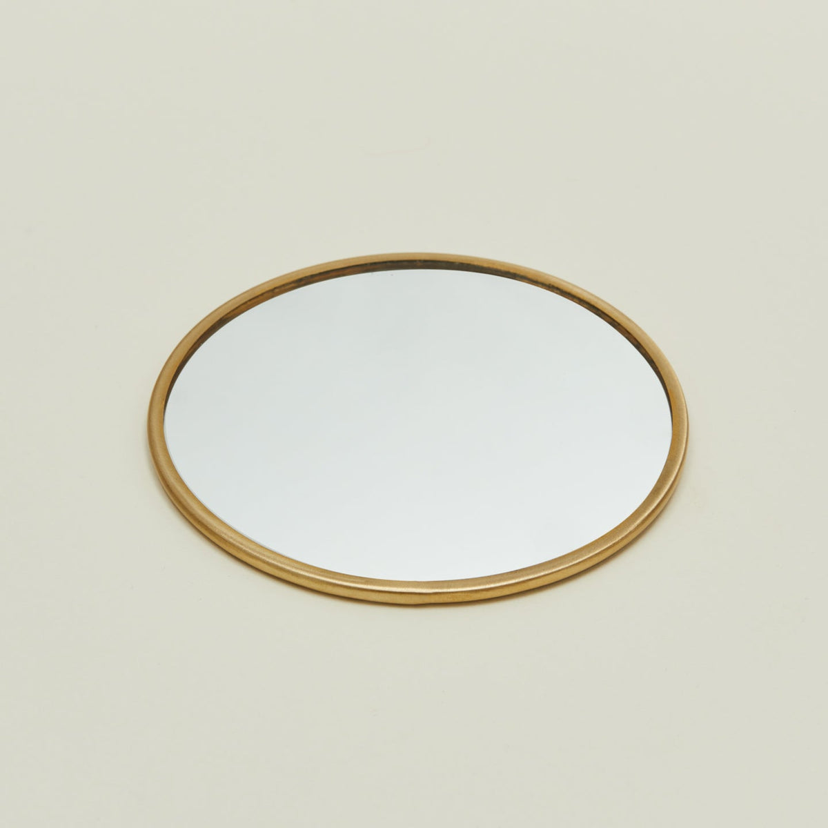 Detailed view of round brass mirror