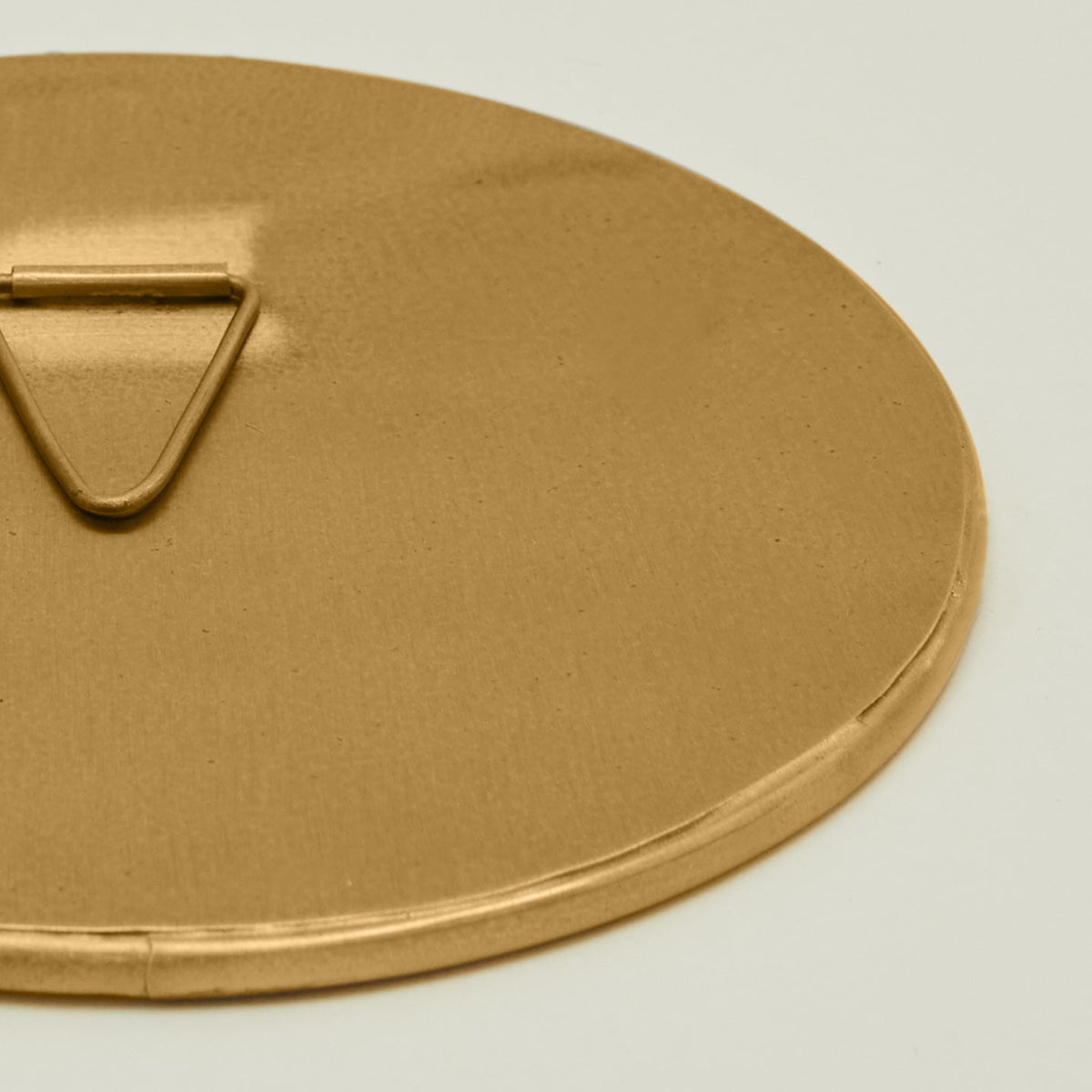 Close up view of round brass mirror.