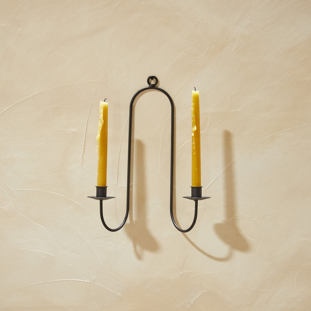 Double Iron Candle Sconce on a plaster wall with candles